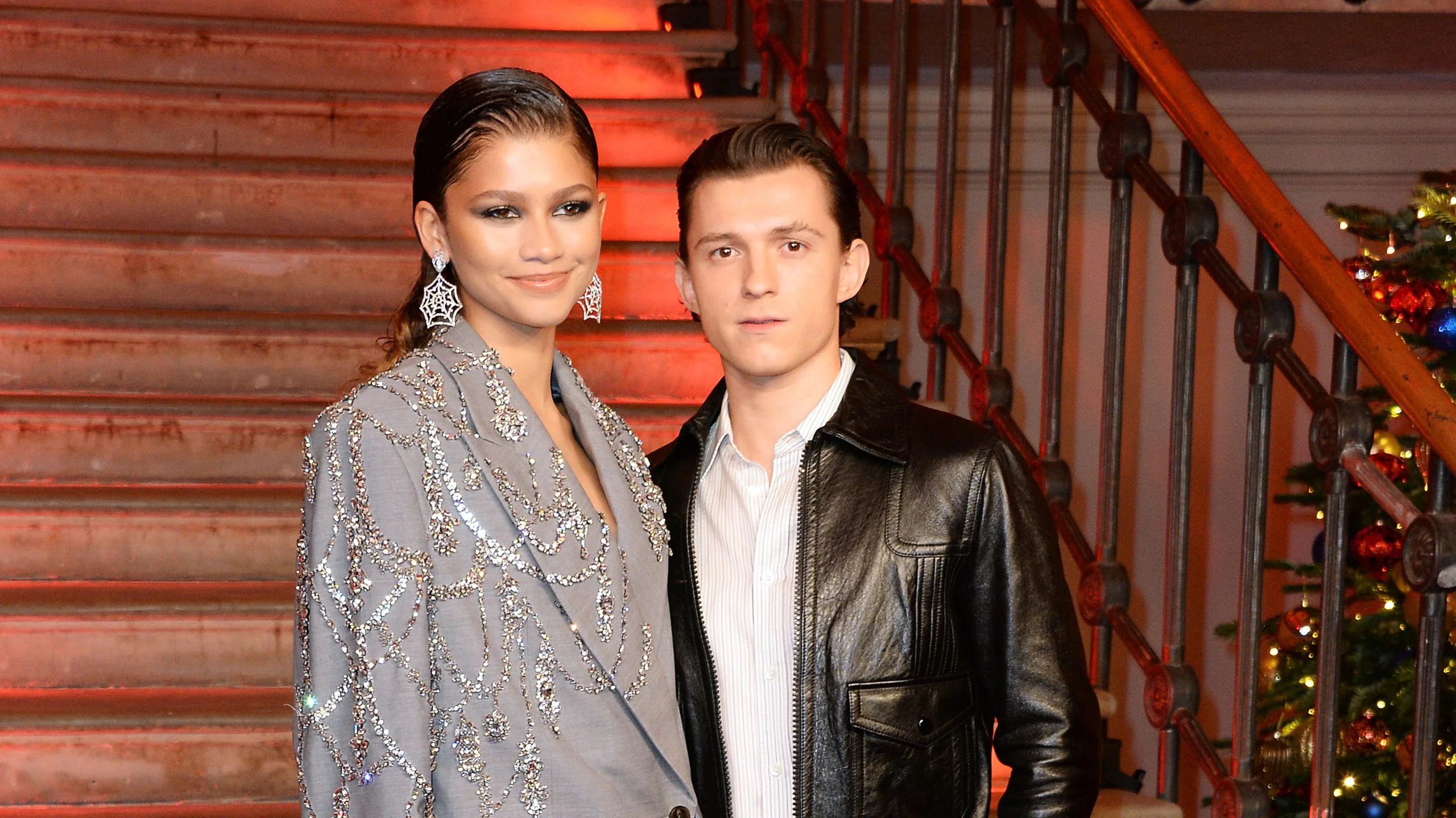 Image may contain Tom Holland Zendaya Clothing Coat Jacket Adult Person Face Head and Blazer