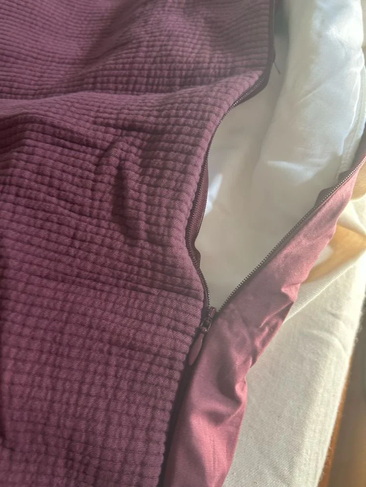 Plum ribbed duvet cover partially unzipped.