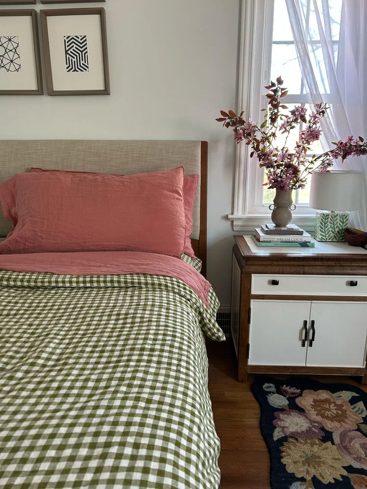 Bed with green gingham duvet cover.