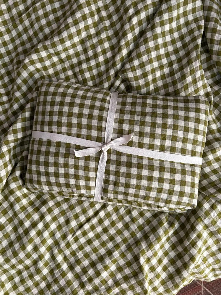 Green gingham linen duvet cover tied up in ribbon.